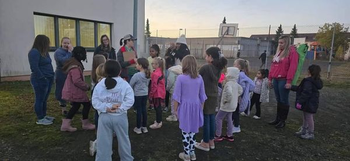 Baumholder Girl Scouts gathered together and listening to Girl Scout leader