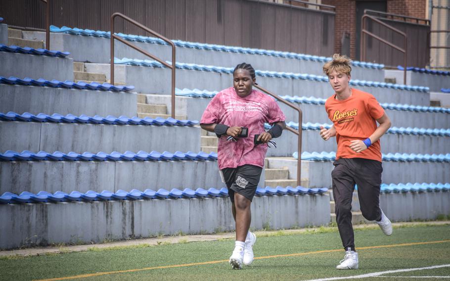 Zavier Jones, an 11th grade student of Osan Middle High School, and Jaxtin Ross, a ninth grade student, run during football practice at Osan Air Base, South Korea, Monday Aug. 5, 2024.