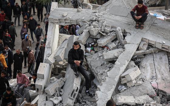 Palestinians from the Abu Anza family search under the rubble of their house after an Israeli airstrike targeted it, killing 14 people in the Rafah refugee camp in the Gaza Strip on March 3, 2024. MUST CREDIT: Loay Ayyoub for The Washington Post