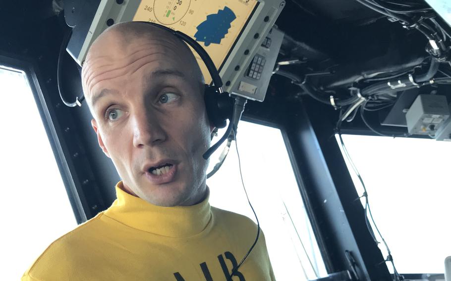 Breaching whales in the Coral Sea put on daily shows for troops aboard the USS America, according to the amphibious assault ship’s “air boss,” Navy Cmdr. Joe Adams.