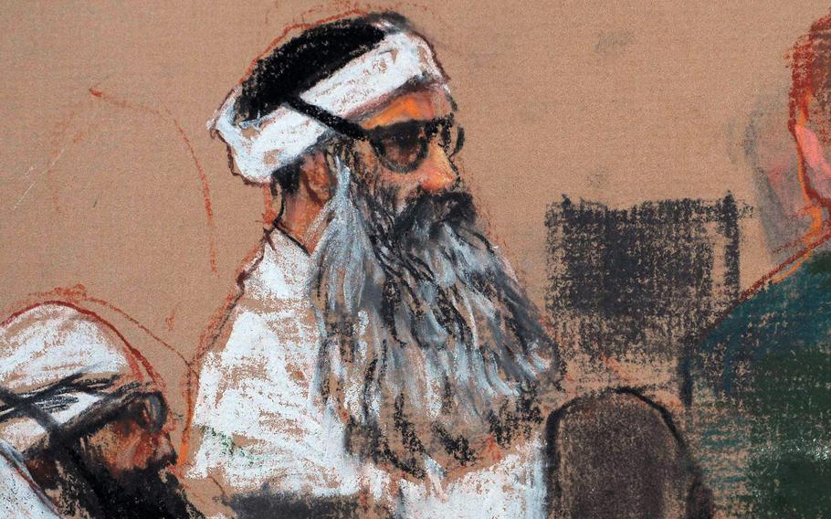 A courtroom drawing depicts a man with a large grey beard wearing a turban and glasses.