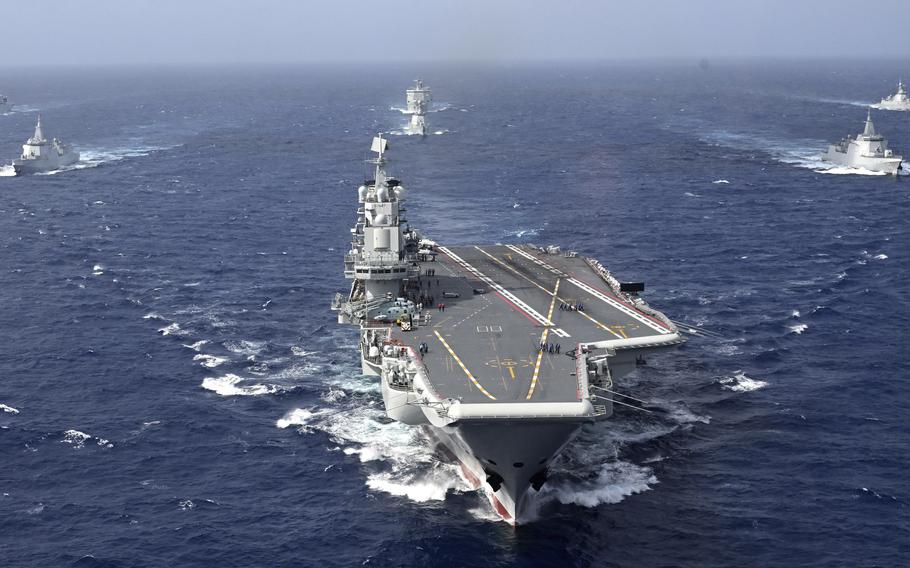 A Chinese aircraft carrier sails in the ocean.