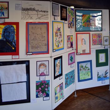 Student artwork is displayed on a white background.