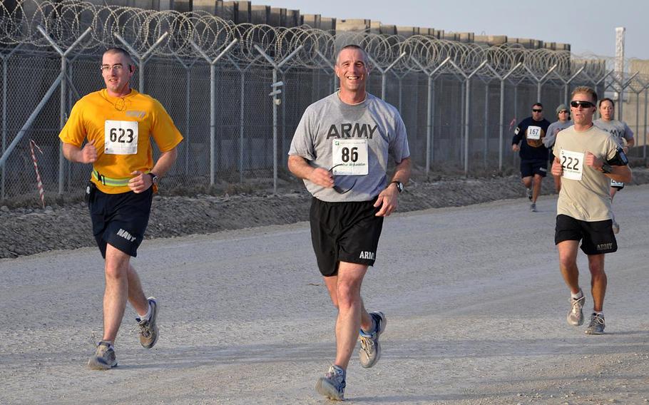 Then-Brig. Gen. Reynold Hoover, head of Joint Sustainment Command in Afghanistan, passes the 9-mile marker during a half-marathon at Kandahar Airfield on March 7, 2010. Hoover is now the CEO for the 2028 Los Angeles Olympic and Paralympic Games.