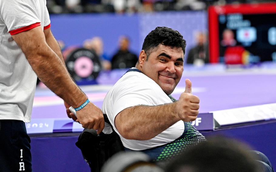 Iranian powerlifter Aliakbar Gharibshahi gives a thumps-up after setting a new Paralympic record on his way to the gold medal in the up to 107-kilogram class at the 2024 Paris Paralympics with a lift of 252 kilograms, or 555.5 pounds.