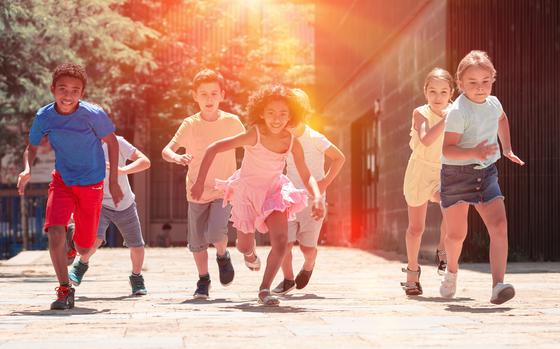 Children running on the sidewalk