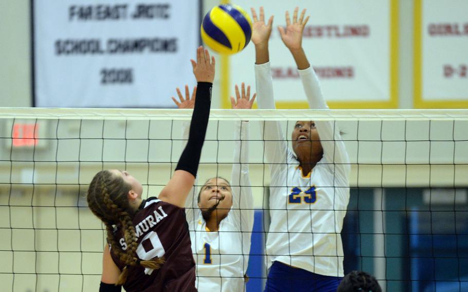 Matthew C. Perry's Presley Valez hits against the double block of Yokota's Trinity Stegall and Coco Jones during Friday's DODEA-Japan girls volleyball match. The Samurai rallied from two sets down to win in five sets.