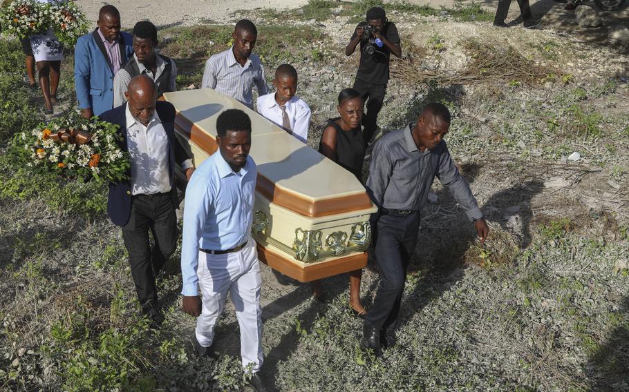 Relatives carry the coffin of someone killed by armed gangs, Pont-Sonde, Haiti, Oct. 8, 2024.