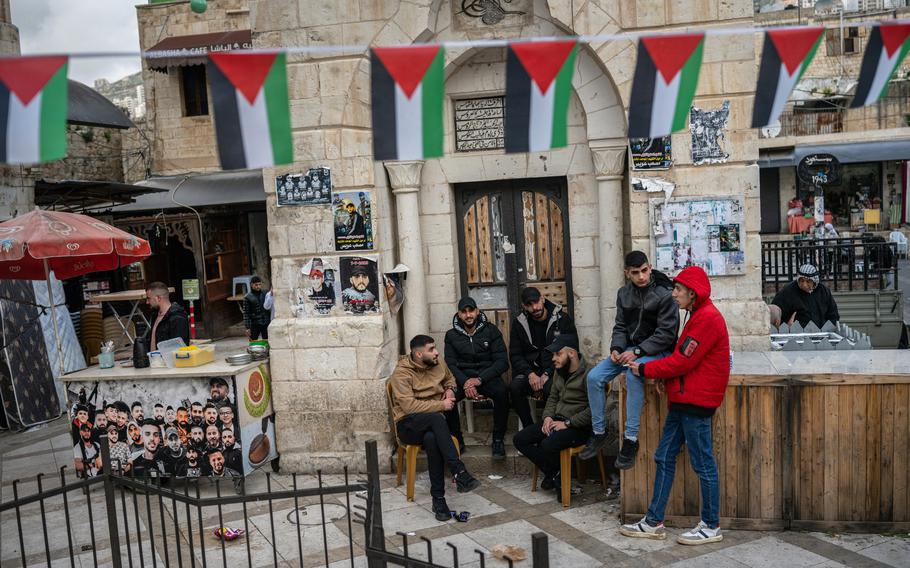 Young men socialize below the Manara Clock Tower in the Old City of Nablus.