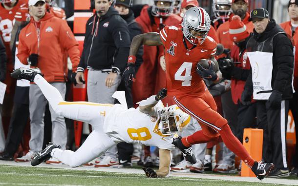 Tennessee linebacker Kalib Perry, left, forces Ohio State receiver Jeremiah Smith (4) out of bounds during the first half in the first round of the College Football Playoff, Saturday, Dec. 21, 2024, in Columbus, Ohio. (AP Photo/Jay LaPrete)