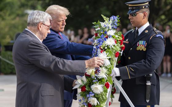 Bill Barnett, left, grandfather of Staff Sgt. Darin Taylor Hoover, and former President Donald Trump place a wreath at the Tomb of the Unknown Solider at Arlington National Cemetery on Aug. 26, 2024.