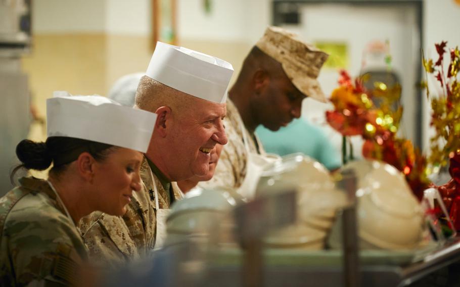 U.S. Marine Corps Maj. Gen. Robert B. Sofge Jr., Commander, Marine Corps Forces Europe and Africa, center, serves food