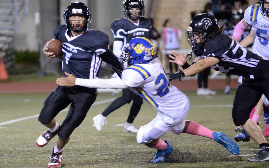 Yokota's Casey Bumpers tries to put the collar on Zama's Roman Romero.