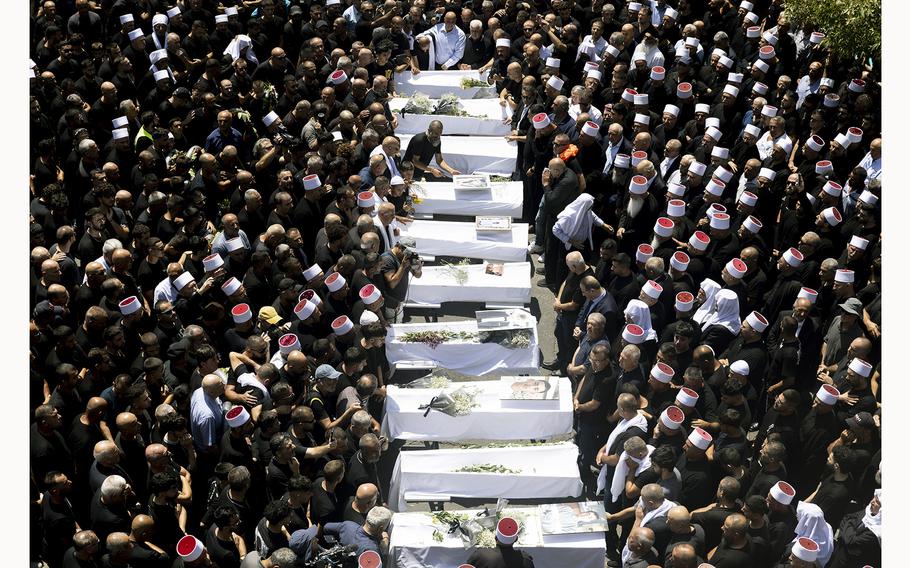 Mourners attend a funeral on July 28, 2024 in Majdal Shams, Golan Heights, held for 10 of the victims of a rocket attack that killed 12 young people on a football pitch in this Druze Arab community. Israel blamed the militant group Hezbollah, with which it has been regularly exchanging fire across the Lebanese border, although the group denied responsibility. 