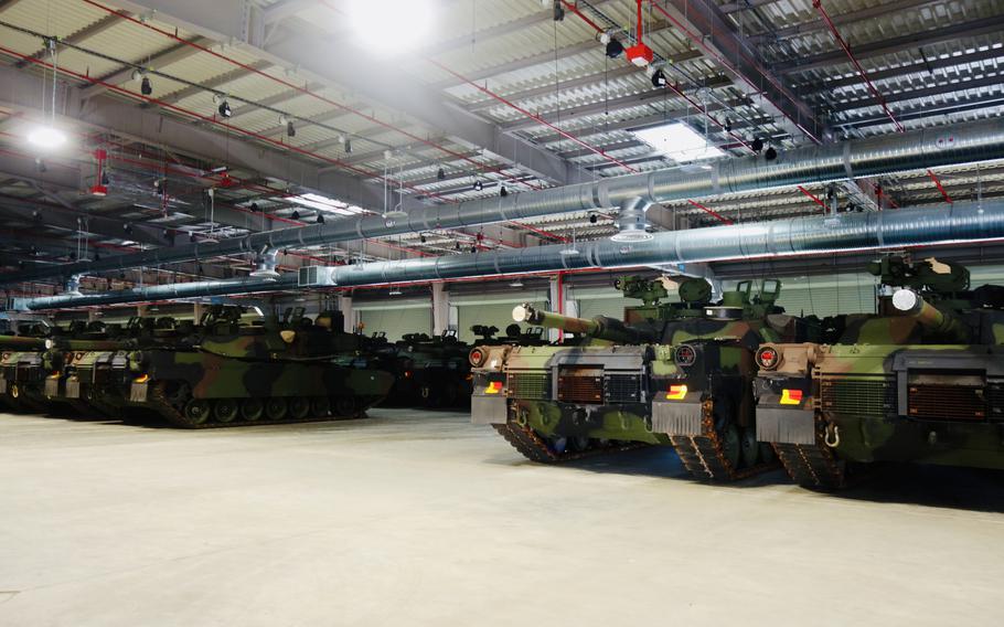 M1 Abrams tanks are lined up at a warehouse in Powidz, Poland.                             