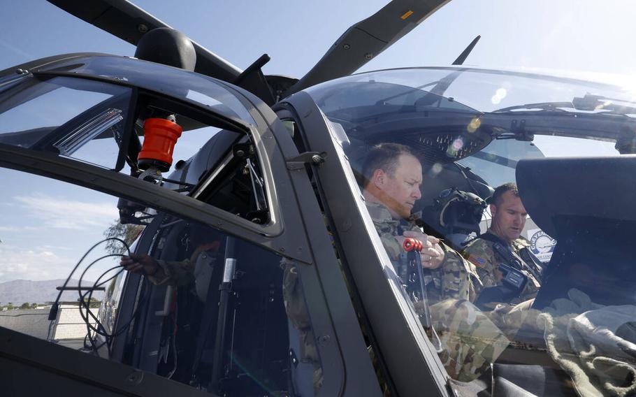 UH-72B Lakota helicopter pilots U.S. Army National Guard Chief Warrant Officer 4 Kevin Keeler, left, and Chief Warrant Officer 3 Tad Casebolt prepare to fly at North Las Vegas Airport, Tuesday, May 16, 2023, in North Las Vegas. 