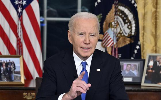 The U.S. president sits in the oval office, wearing a suit with a blue tie and gesturing with a finger as he speaks.