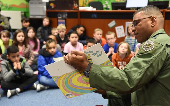 Retired Lt. Gen. Richard Clark, formerly the 3rd Air Force commander, reads to students at Ramstein Intermediate School in Germany in March 2017. Certain books in libraries at Defense Department schools like Ramstein are being temporarily removed from shelves pending a review for compliance with recent executive orders.