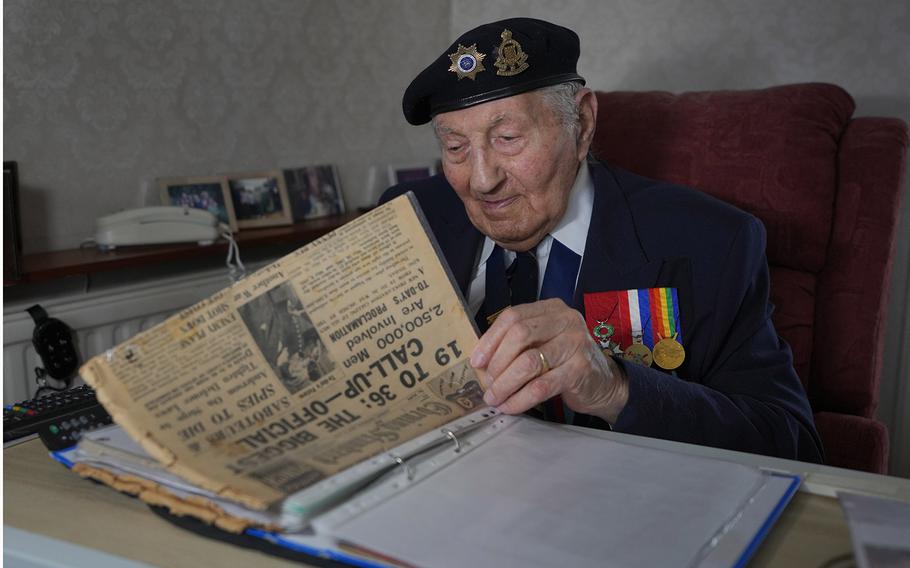 Mervyn Kersh looks through documents and newspapers from World War II at his home in London on April 8, 2024.