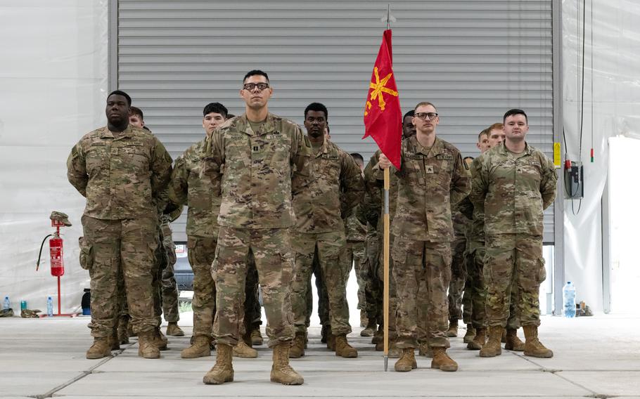 Soldiers stand at attention.