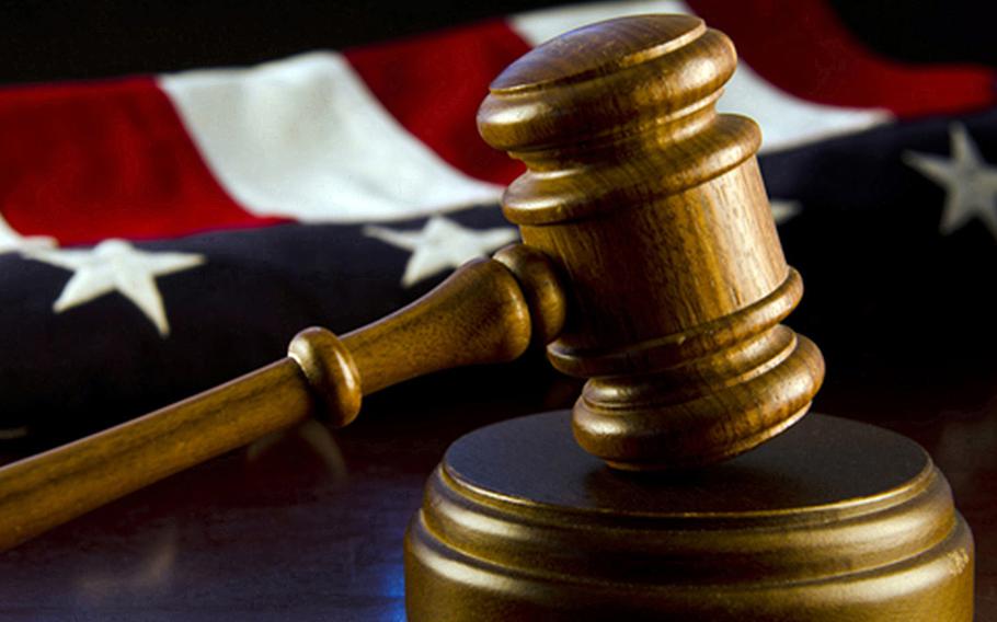 A stock photo of a gavel with an American flag background.