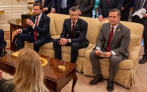 An official meeting in the Oval Office with a crowd watching as Trump and Rutte speak to each other.