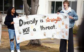 High school students Michele Holloway and Liam Boyd hold a sign that reads, “Diversity is strength not a threat.”