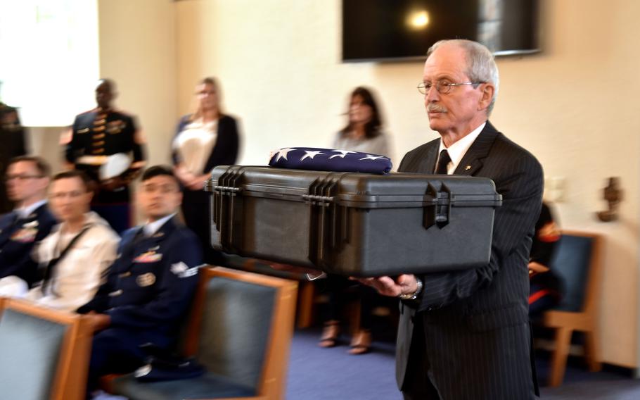 Manfred Hofmeyer, a retired German army brigadier general and board member of the German War Graves Commission, carries a box containing the remains of Army 1st Lt. Nathan Baskind into the Landstuhl Regional Medical Center chapel in Germany on May 28, 2024. The Germans turned over the remains to Army mortuary affairs officials at a dignified recovery of remains ceremony. Baskind will be reburied next month in Colleville-sur-Mer, France.