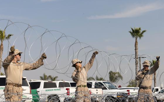 U.S. Marines set up concertina wire near Imperial Beach, California, during a deployment to the southern border, Jan. 24, 2025. U.S. Northern Command is working together with the Department of Homeland Security to augment U.S. Customs and Border Protection along the southern border with additional military forces. This initial deployment of 1,500 active-duty personnel brings the total military Title 10 forces along the border to nearly 4,000 personnel. (U.S. Marine Corps photo by Lance Cpl. Caleb Goodwin)