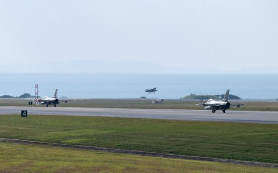 An F-35A Lightning II assigned to the 134th Expeditionary Fighter Squadron lands while F-16C Fighting Falcons assigned to the 77th Expeditionary Fighter Squadron taxi at Kadena Air Base, Okinawa, Jan. 13, 2025.