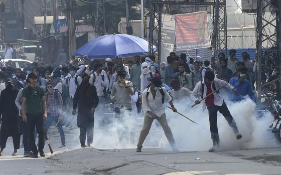 Police fire tear gas to disperse students protesting over an alleged on-campus rape in Punjab, in Rawalpindi, Pakistan, Thursday, Oct. 17, 2024. (AP Photo/W.K. Yousafzai).