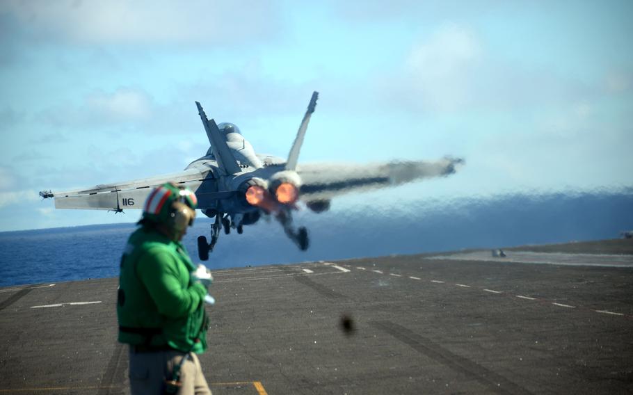 An F-18 Super Hornet takes off from the USS Ronald Reagan during a multi-carrier exercise in the Philippine Sea, Monday, Nov. 6, 2023.