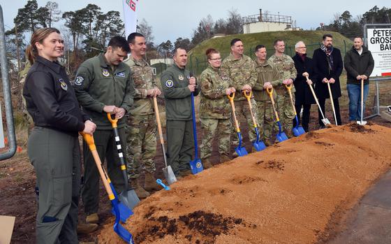 Airmen from Ramstein Air Base, Germany, join 86th Airlift Wing leaders and construction experts at a ceremonial shovel digging Jan. 24, 2025, to mark the beginning of construction the 37th Airlift Squadron's operations facility. Work on the $23 million project will take place over the next couple of years.