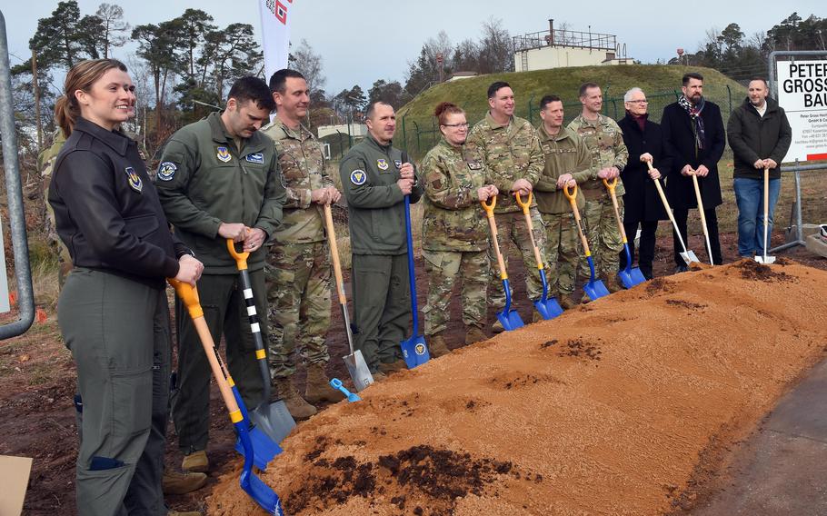 Men and women in uniform in a groundbreaking ceremony.