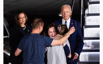 Kurmasheva hugs her family after greeting Biden and Vice President Kamala Harris at Joint Base Andrews, Md., on Aug. 1, 2024.