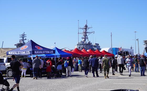 Crowds of people walking around and looking at different booths