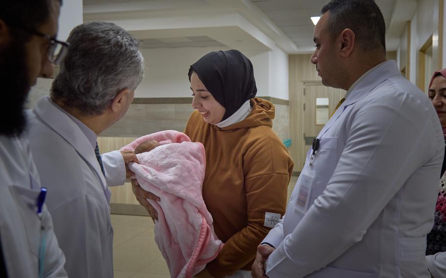 Shaima Abu Khater shows her daughter, Kinda Lulu, 3 months, to doctors in the neonatal unit at the hospital on Feb. 4, 2024.