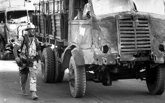 Mogadishu, Somalia, Jan. 3, 1993: A U.S. Marine guarding the gate to the port in Mogadishu loses his temper with a Somali trucker hauling grain donated by relief organizations. The Marine was upset because the convoy of trucks hauling the food were blocking the traffic leading into the port. 

Interested in Stars and Stripes' coverage of the operations in Somalia? Subscribe to Stars and Stripes’ historic newspaper archive! We have digitized our 1948-1999 European and Pacific editions, as well as several of our WWII editions and made them available online through https://starsandstripes.newspaperarchive.com/

META DATA: Somalia; Operation Restore Hope; 