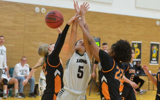 AFNORTH's MadelyneHatfield gets stuck between the Spangdahlem defense of Kylie McVey and Brooklyn Shakir-Baccus in a girls Division III semifinal at the DODEA-Europe basketball championships in Wiesbaden, Germany, Feb. 14, 2025. AFNORTH won the game 39-20 to advance to the division final against Hohenfels.