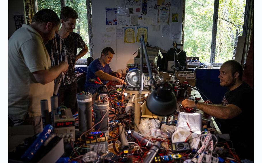 Volunteers build Power Kit power banks for the Ukrainian military using lithium batteries from used e-cigarettes in Kyiv, on July 1, 2023.