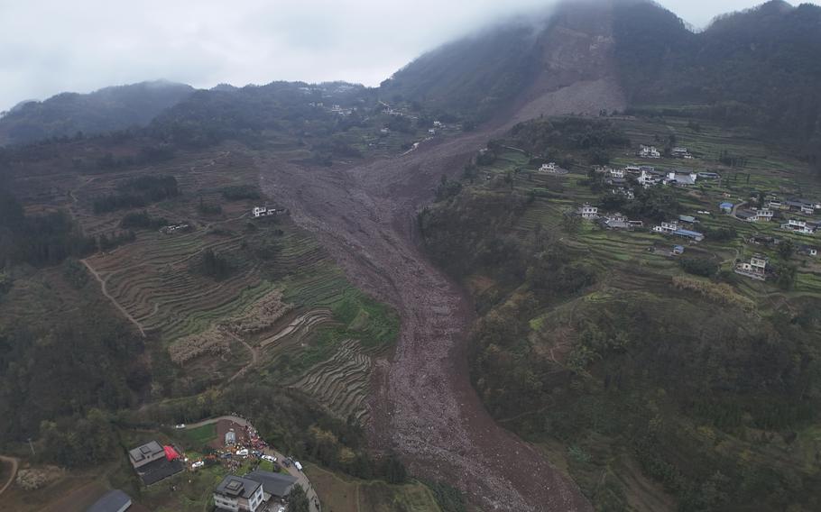 In this photo released by Xinhua News Agency, an aerial drone photo shows the site of a landslide in Jinping Village, Junlian County in the city of Yibin, southwest China’s Sichuan Province.