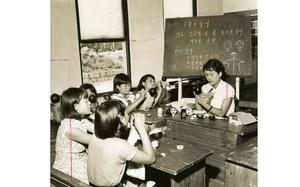 Seoul, South Korea, September 1959: Children carefully paint the features on puppets in one of the classroom of the Seoul Children's home. The girls live at the orphanage together with some 250 other war orphans. The home -- originally named Munske Orphanage and founded by Col. Charles A. Munske in July 1951 -- was set up with the aid of United States and United Nations servicemen for children often found wandering the battle fields. In 1952 the orphanage was nationalized under the Ministry of Health and Social Services and renamed. In 1955 the home was moved to its current location and the children were housed in tents until the new buildings were completed in August 1957.

Pictured here is a scan of the original 1959 print created by Stars and Stripes Pacific's photo department to run in the print newspaper. The red marks indicate the crop lines. Only the middle part of the image would appear in the newspaper. As the vast majority of pre-1964 Stars and Stripes Pacific negatives and slides were unwittingly destroyed by poor temporary storage in 1963, the prints developed from the late 1940s through 1963 are the only images left of Stripes' news photography from those decades – with the exception the negatives of some 190 pre-1964 photo assignment found recently. Stars and Stripes' archives team is scanning these prints and negatives to ensure their preservation. 

Stars and Stripes' Pacific archives house many images of South Korean children affected by the Korean War. Many are of orphans living in homes founded and/or funded by either U.S. servicemembers or the United Nations. Also found in our archives are images of so-called "Unit Mascots," children orphaned by the war who were "adopted" by U.S. military units. The children would live on base or in camp with the unit and were often outfitted in smaller versions of the unit's uniform. Some ended up being legally adopted by a servicemember and went on to live in America. 

Some of these images of "unit mascots" 