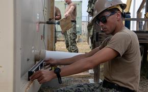 250220-N-EH855-1011 GUANTANAMO BAY, Cuba (February 20, 2025) A U.S. service member sets up a shower unit at Naval Station Guantanamo Bay in support of the Department of Defense and Department of Homeland Security mission to expand the Illegal Alien Holding Operations Center during Operation Southern Guard at Naval Station Guantanamo Bay, Cuba, February 20, 2025. At the direction of the President of the United States to the Department of Homeland Security (DHS) and the Department of Defense, U.S. military service members are supporting removal operations led by DHS at Naval Station Guantanamo Bay. (U.S. Navy photo by AFN Guantanamo Bay Public Affairs)