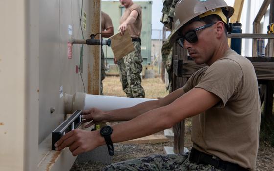 250220-N-EH855-1011 GUANTANAMO BAY, Cuba (February 20, 2025) A U.S. service member sets up a shower unit at Naval Station Guantanamo Bay in support of the Department of Defense and Department of Homeland Security mission to expand the Illegal Alien Holding Operations Center during Operation Southern Guard at Naval Station Guantanamo Bay, Cuba, February 20, 2025. At the direction of the President of the United States to the Department of Homeland Security (DHS) and the Department of Defense, U.S. military service members are supporting removal operations led by DHS at Naval Station Guantanamo Bay. (U.S. Navy photo by AFN Guantanamo Bay Public Affairs)