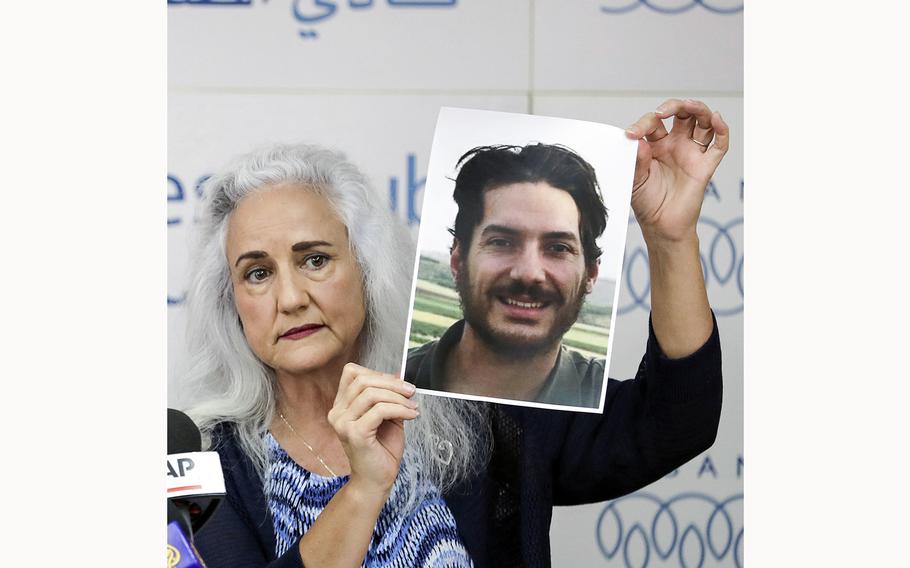 Debra Tice, mother of kidnapped journalist Austin Tice, holds a portrait of the Marine veteran during a briefing in Beirut, Lebanon, on July 20, 2017. 