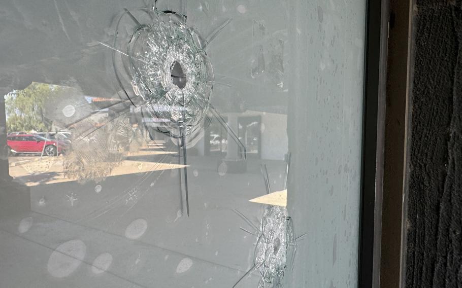 Bullet holes in the glass window at a Democratic Party campaign office in Tempe, Ariz., Sept. 25, 2024.