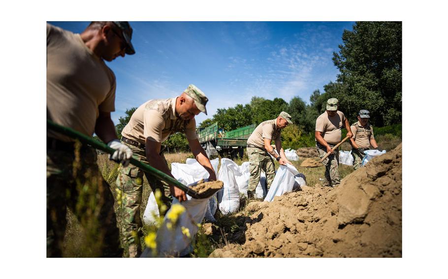 Romanian Army soldiers build a bomb shelter in the village of Plauru, Danube Delta, east of Bucharest, Romania, on Sept. 12, 2023.