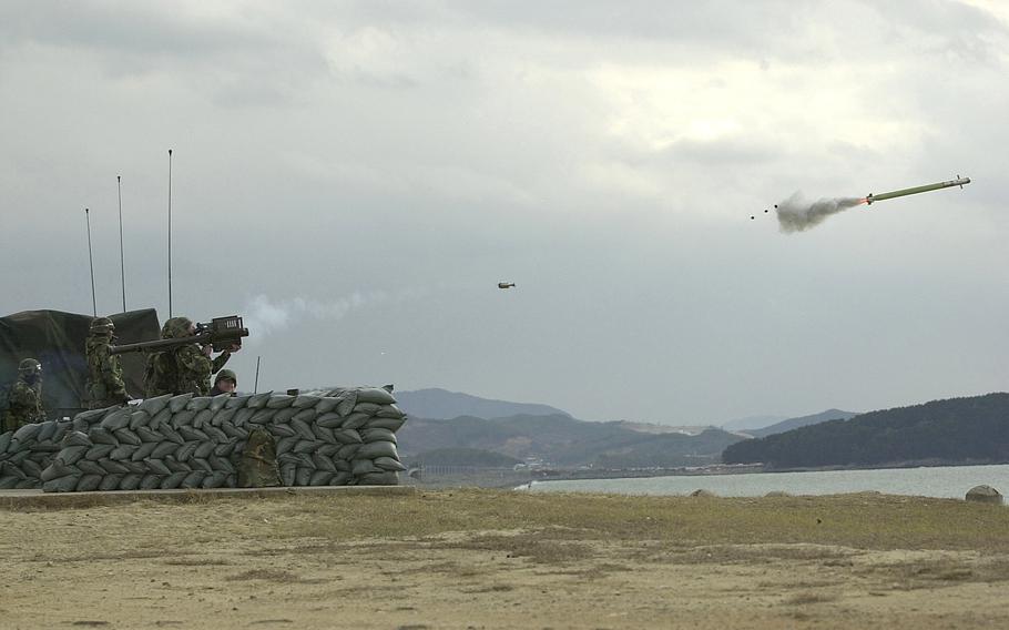 Army Pfc. Jeremiah Houghton, Delta Battery 5 Battalion 5th Air Defense Artillery, Camp Casey, fires a Stinger at a Ballistic Aerial Target (BAT) at the Chulmae Range, Korea, during Operation Sea Strike, Nov. 27, 2001.