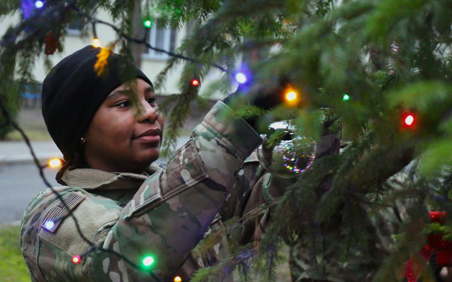 U.S. Army Pfc. Blessyn Moore, a supply specialist assigned to Charlie ‘Wild Card’ Company, 2nd Cavalry Battalion, 12th Cavalry Regiment, 1st Armored Brigade Combat Team, 1st Cavalry Division, hangs up a silver ornament 