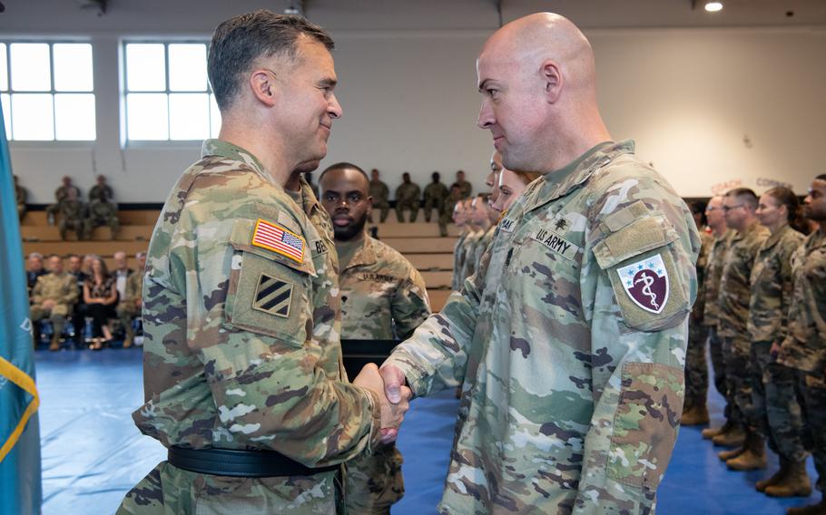 Sgt. Maj. Ilker Irmak of the 68th Theater Medical Command shakes hands with Lt. Gen. Sean Bernabe at a patching ceremony on Sembach Kaserne, Germany, Sept. 20, 2024.